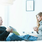 couple-relaxing-at-home-with-hot-beverages